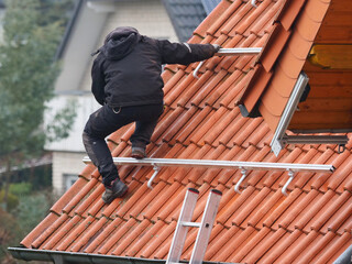 Worker on the roof installing a solar power system