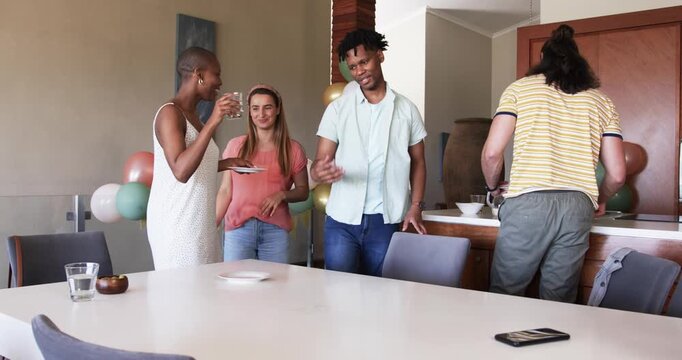 At party, Friends gathering at home, preparing table for celebration, smiling and chatting