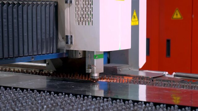 Close Up Shot Of A CNC Machine Precision Cutting Steel Sheet During Manufacturing Process.