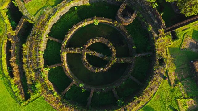 Drone ascends over Baluarte de San Diego at sunrise in Intramuros Manila