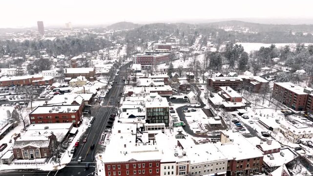 Snow-covered Town Buildings With Town Hall And Episcopal Church In Winter In Amherst, Massachusetts. - aerial pullback shot