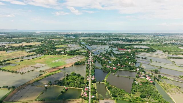 Slow forward drone flight, narrow rural road in Lingayen Pangasinan Philippines