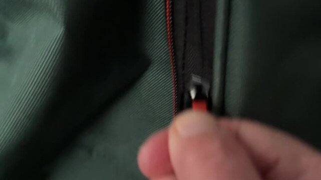 Zipping zipper pull on a travel bag, video with sound.
