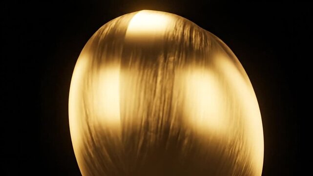 Golden brushed metallic heart on dark background