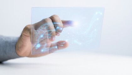 Hand touching a transparent screen with glowing tech graphics suitable for technology concepts, digital innovation, future technology, and virtual reality.
