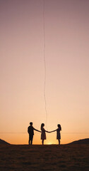 Fototapeta premium Silhouettes of two people standing apart but connected by a single, glowing thread of light, minimalist landscape at sunset