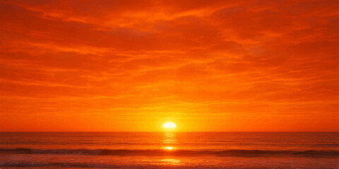 Obraz premium A beautiful orange sunset reflects over the calm ocean waves as the sun meets the horizon under a glowing summer sky