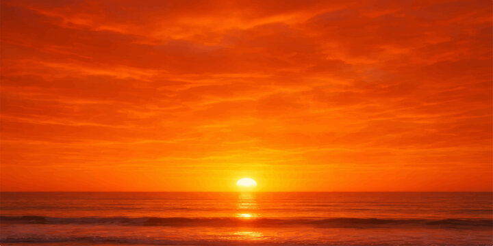 A beautiful orange sunset reflects over the calm ocean waves as the sun meets the horizon under a glowing summer sky