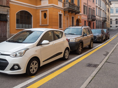 Hyundai i10 and Land Rover Freelander parked along a street with colorful European architecture