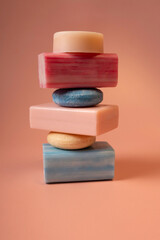 Stacked soap and shampoo bars arranged in a minimalist composition on a pastel background. The image emphasizes texture and soft colors, suitable for skincare, haircare, wellness, and clean design