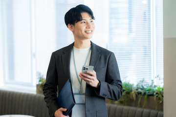 オフィスでスマホを使うビジネスマン