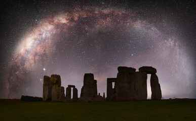 Ancient stone circle silhouetted with Milky Way galaxy in the background - UK