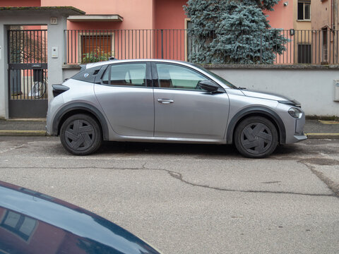 Lancia Ypsilon 2024 hybrid car parked on a city street, showcasing modern Italian design and future mobility