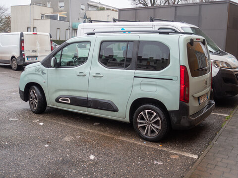 Citroen Berlingo parked in an urban area, a European family car, light green model for modern transportation