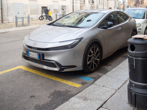 Toyota Prius XW60 hybrid car parked on urban street, showcasing modern design and sustainable transportation
