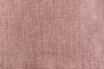 Fototapeta premium Pink fabric texture background. Macro shot of soft pink linen cloth material. Detailed textile weave pattern for fashion, interior design, or craft backdrop.