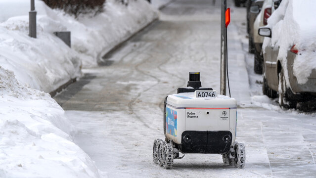 Moscow, Russia, February 01, 2026: Yandex delivery robot in the snow