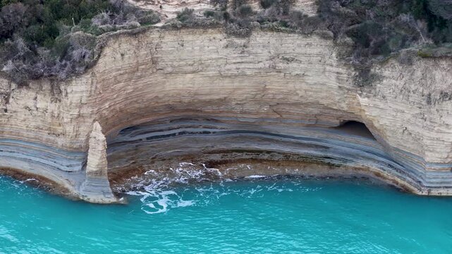 Aerial Detail of Layered Sandstone Cliff and Sea Cave with Turquoise Water at Canal d'Amour Sidari Corfu Greece