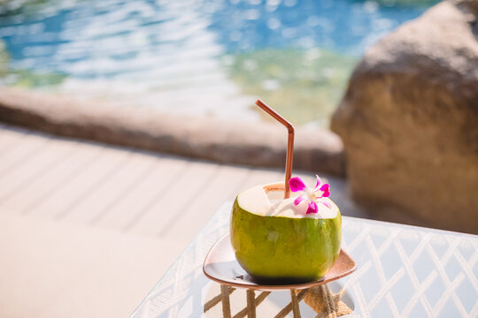 Fresh coconut juice on a wooden table