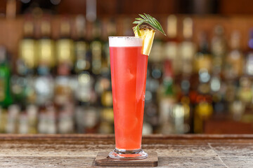 Cocktail singapore sling on a background of a bar rack