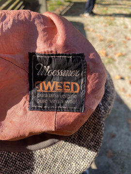 Close-up of a Moessmer tweed label indicating pure virgin wool fabric