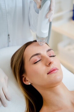 Needle fractional RF facelift procedure in professional medical cosmetology clinic.