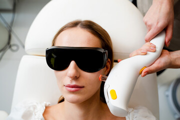 Rosacea treatment with IPL laser equipment in clinic.