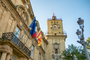 Historic stone clock tower rising above narrow streets in Aix-en-Provence
