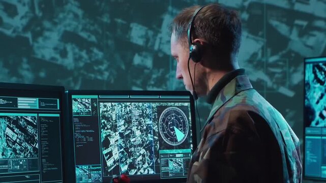 Soldier in a dimly lit military control room, intensely focused on multiple computer screens displaying crucial operational drone data.
