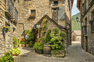 Traditional stone house with flowers in Torla-Ordesa village Pyrenees Spain