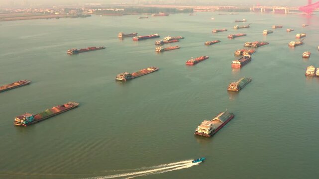 Busy Harbor with Anchored Cargo Ships at Sunrise - Aerial View