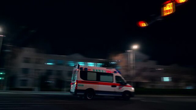 Emergency Ambulance Speeding Through Night City Street