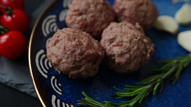 Baked meatballs on a slate serving board arranged in two rows of three