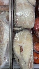 Raw wolffish steak displayed in seafood market refrigerator  