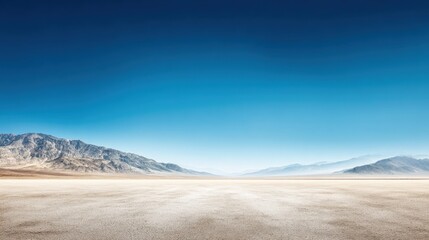 Vast Desert Landscape Under Clear Blue Sky with Distant Mountains