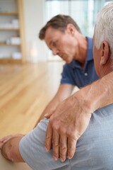 Healthcare professional providing rehabilitation massage and relief with hands to an older adult patient shoulder, focusing on recovery and physical health.