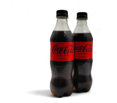Photo of two refreshing Coca-Cola zero sugar bottles, isolated on white background with space for text.