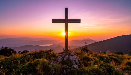 Wooden cross stands atop a hill, bathed in a warm, vibrant sunset over mountains. Peaceful, serene landscape