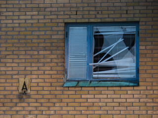 Old industry building in Gothenburg with broken window and exposed structure shows signs of neglect and decay over time