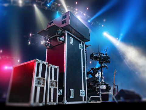 Live event technical setup prepares professional stage equipment and audiovisual gear before a concert. Sound engineering, lighting control, stage production and show logistics.