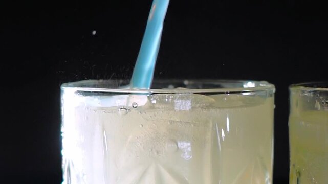 Delicious alcoholic cocktail made with jin tonic and ice in glasses for relaxing at night and refreshing in the summer. Spices and green lime for flavor. Bartender and bar. Rosemary burns with fire