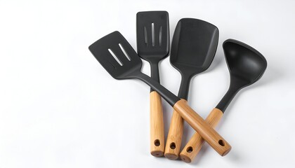 Four black cooking utensils with wooden handles on a bright white background