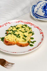 Wheat toast with omelette and green pesto sauce on a plate at a hotel