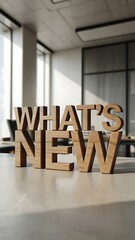 Wooden Whats New Sign on Office Table with Modern Interior Background