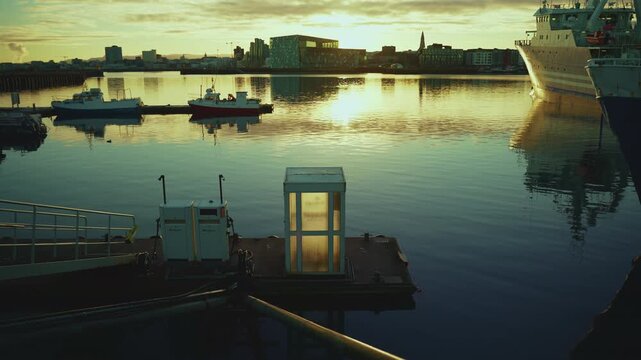REYKJAVIK, ICELAND - JANUARY 31 2026: Ship refueling station at the pier with Harpa, Hallgrimskirkja and large vessels at dawn, 4K.
