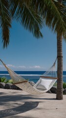 Peaceful Hammock Tied Between Palm Trees Overlooking a Serene Ocean View
