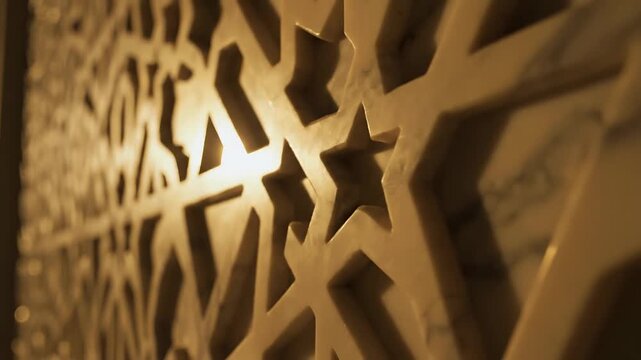 Close-up of Islamic Geometric Pattern Carved in White Marble Wall with Warm Backlighting