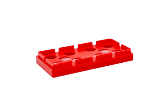 Red plastic building block for children to play