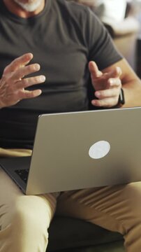 Mature man deep in thought while working on laptop at home. Remote working businessman looking for solution and new ideas. Male entrepreneur managing business online, thinking.