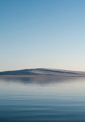 Obraz premium Abstract, minimalist image showing a smooth, flowing horizon line separating pale blue sky and calm, reflective water, offering vast negative space ,sky ,horizon ,soft gray